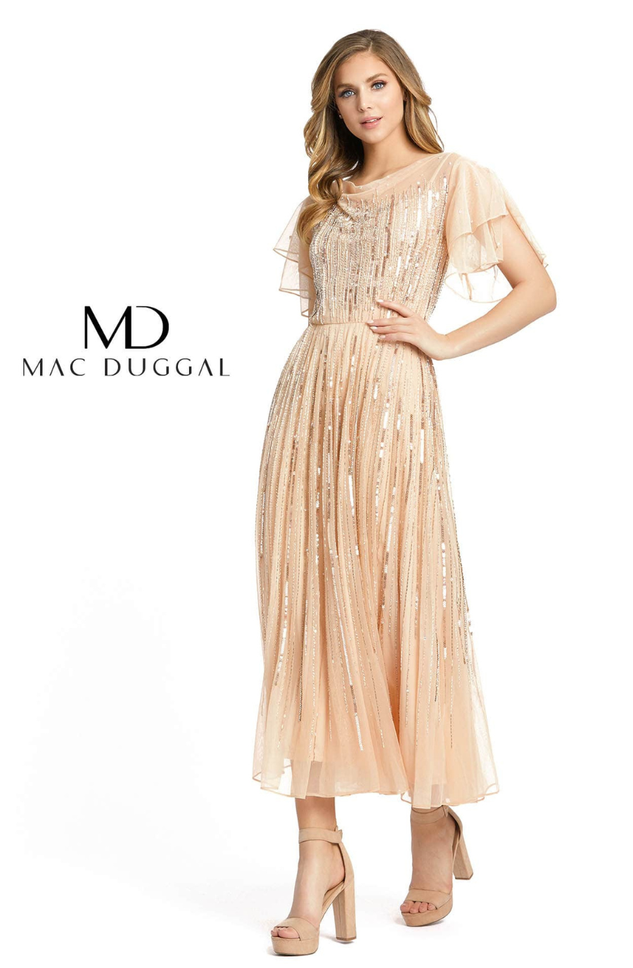 Model is wearing a champagne cocktail dress with flutter sleeves 