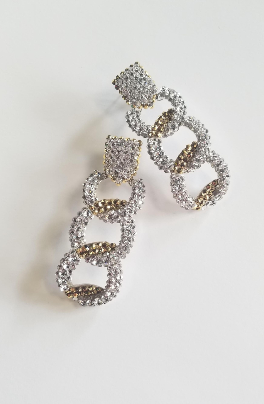 image shows glittery dangly earrings