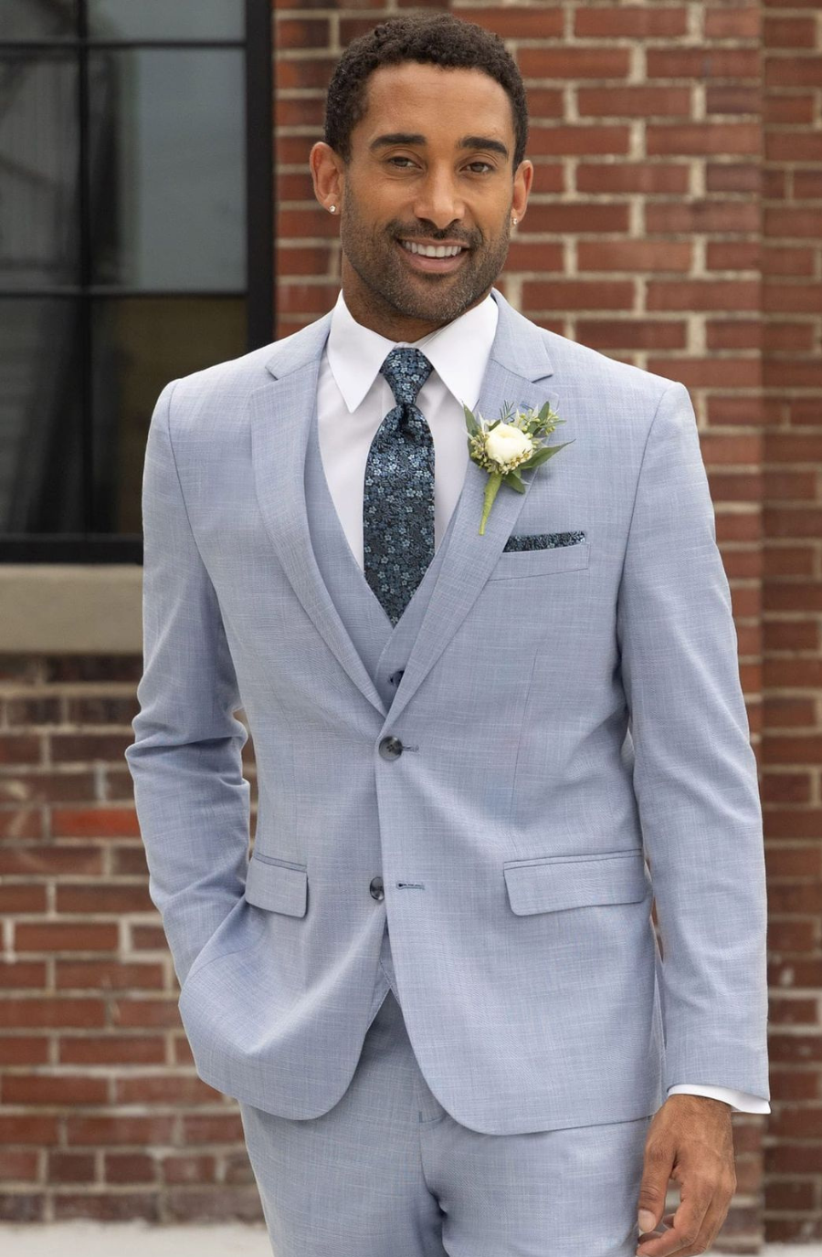 Model is wearing a light grey suit with a white shirt