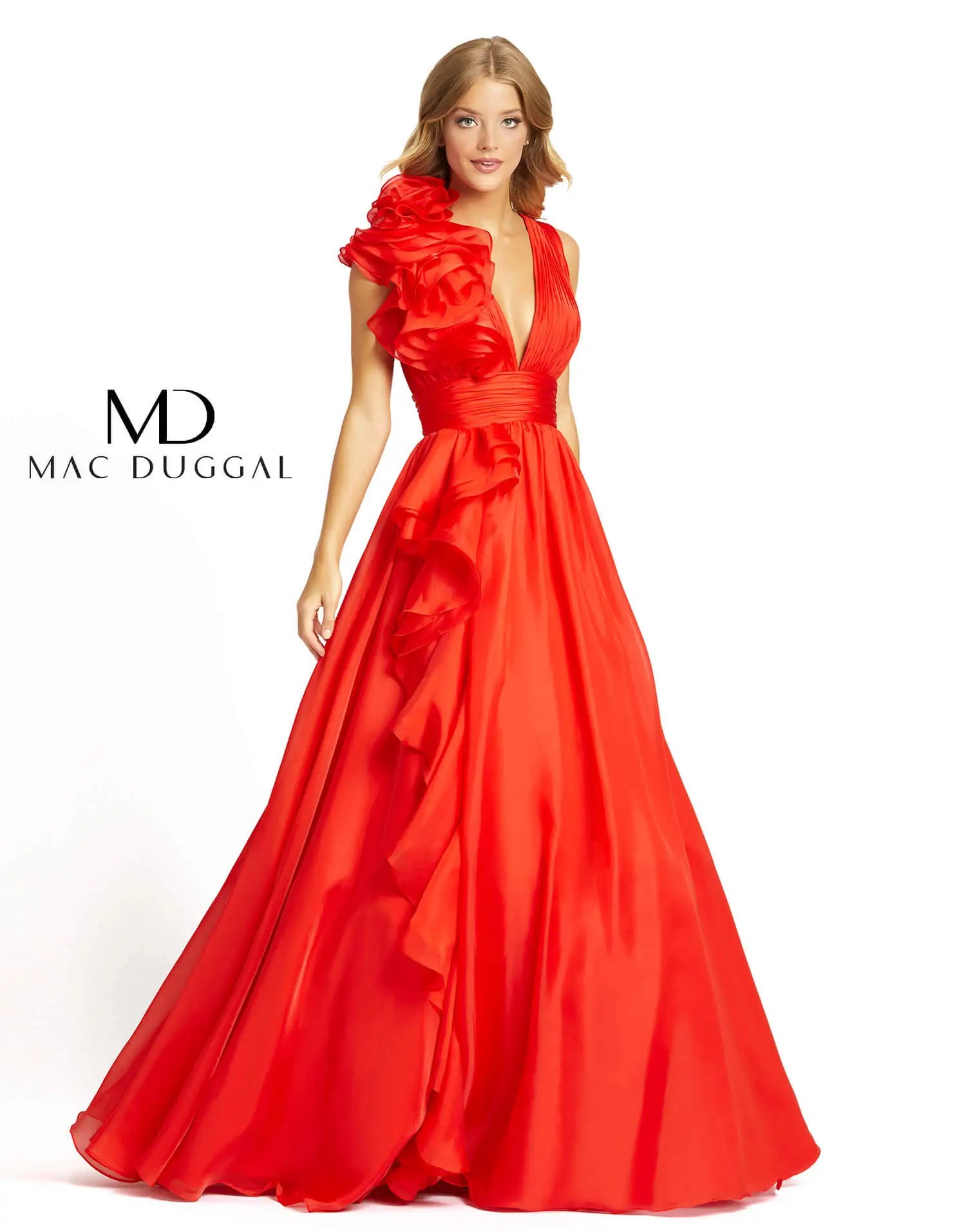 Model is wearing a sleeveless red evening gown with floral embellishments on the bodice and skirt