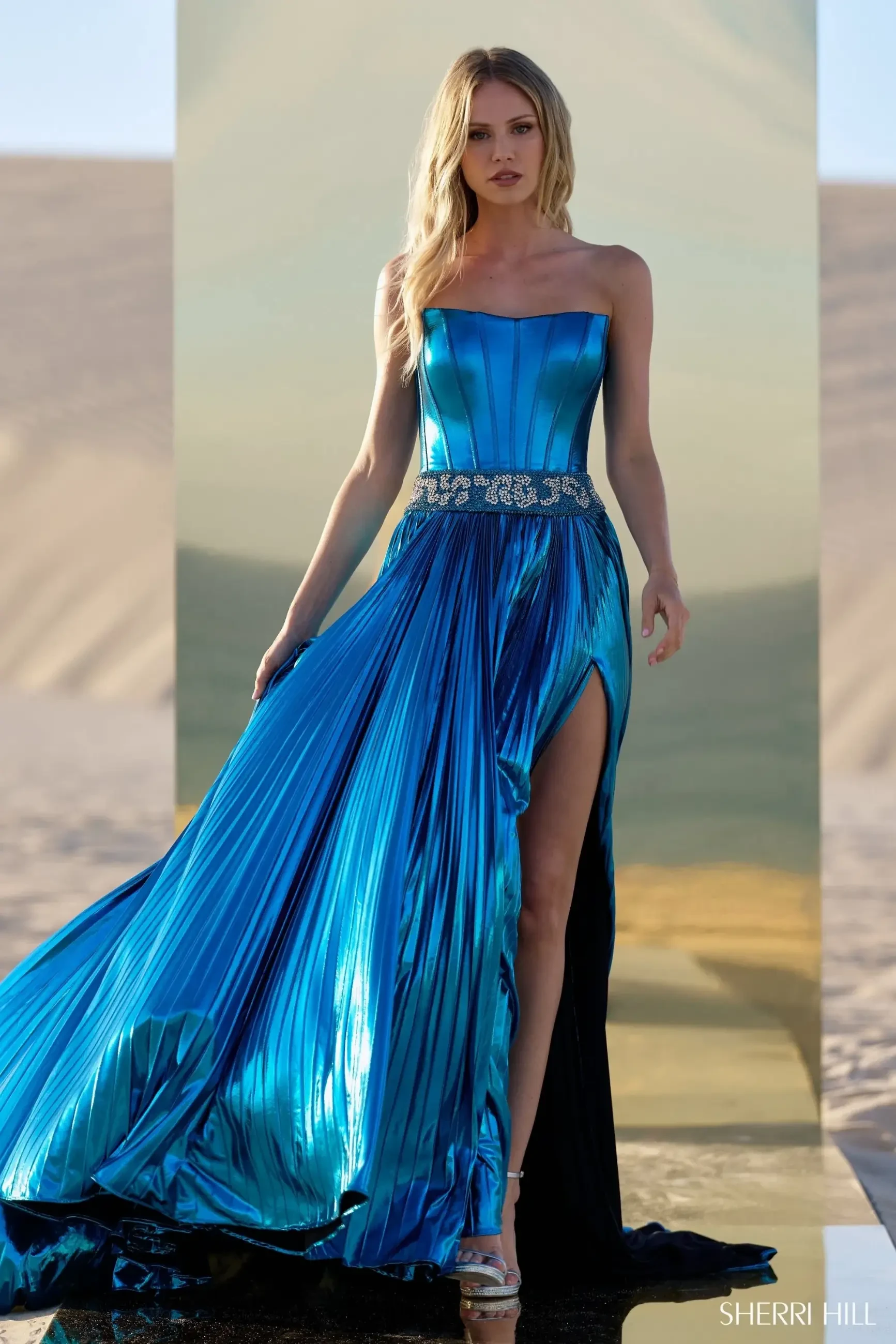 model is wearing a strapless floor length electric blue evening gown