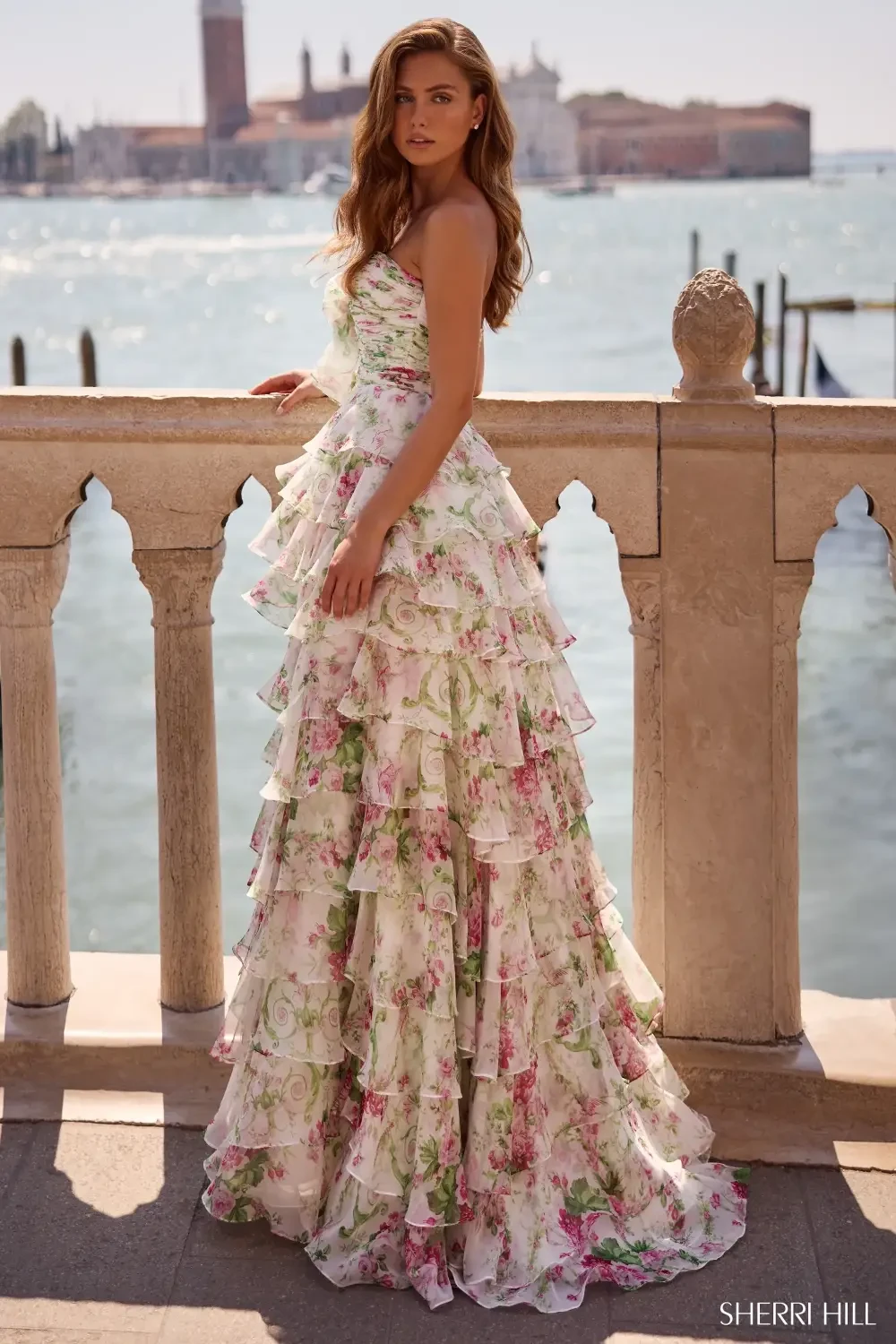 model is wearing a strapless floral prom dress