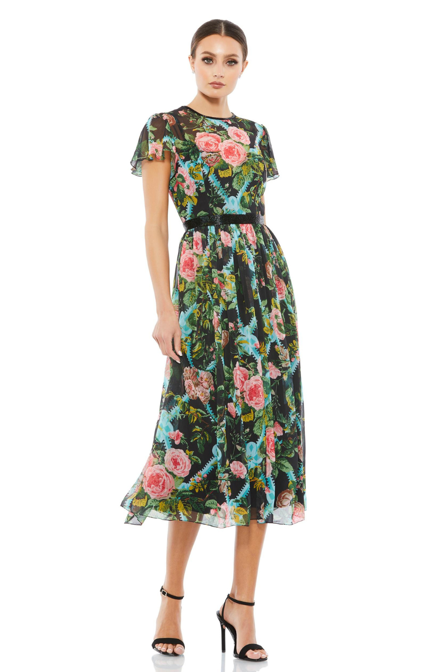 Model is wearing a floral cocktail dress with flouncy sleeves